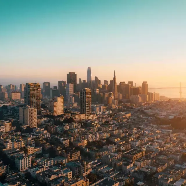 The skyline of 威尼斯人官网平台app is seen from the air in a golden light.